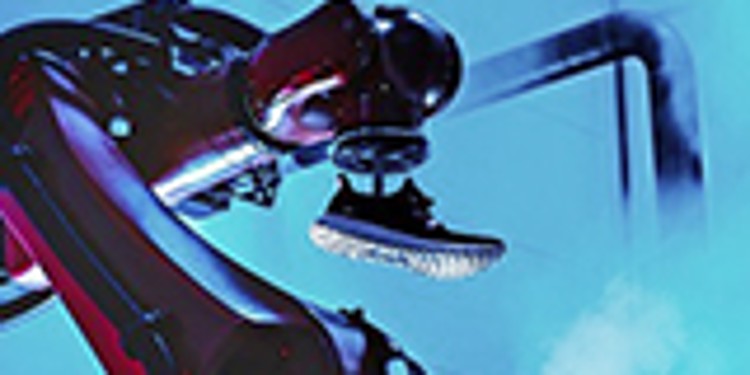 A production robot holding a sports shoe