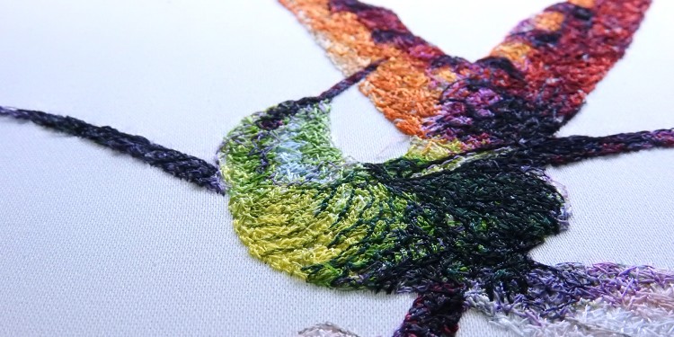 Embroidered bird with many different yarn colors