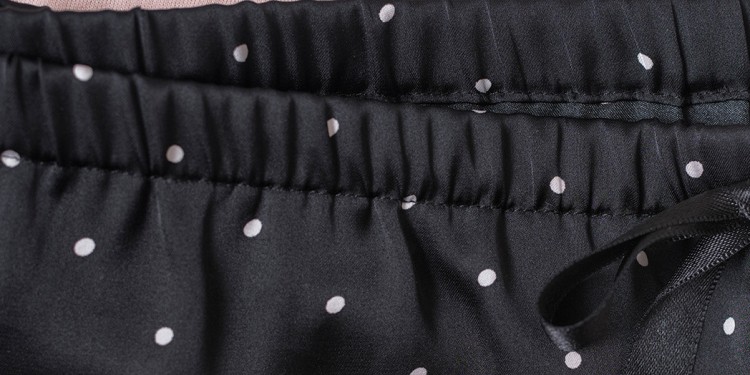 Seam on a black fine-knitted fabric